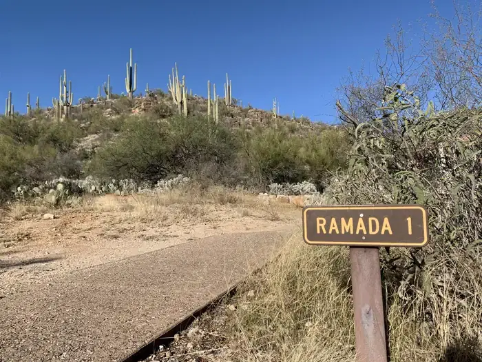 Paved path to the left of a sign saying "Ramada 1"
