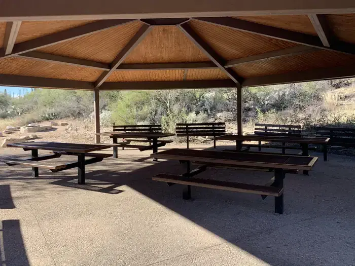 Under the ramada, with a view of picnic tables and benches