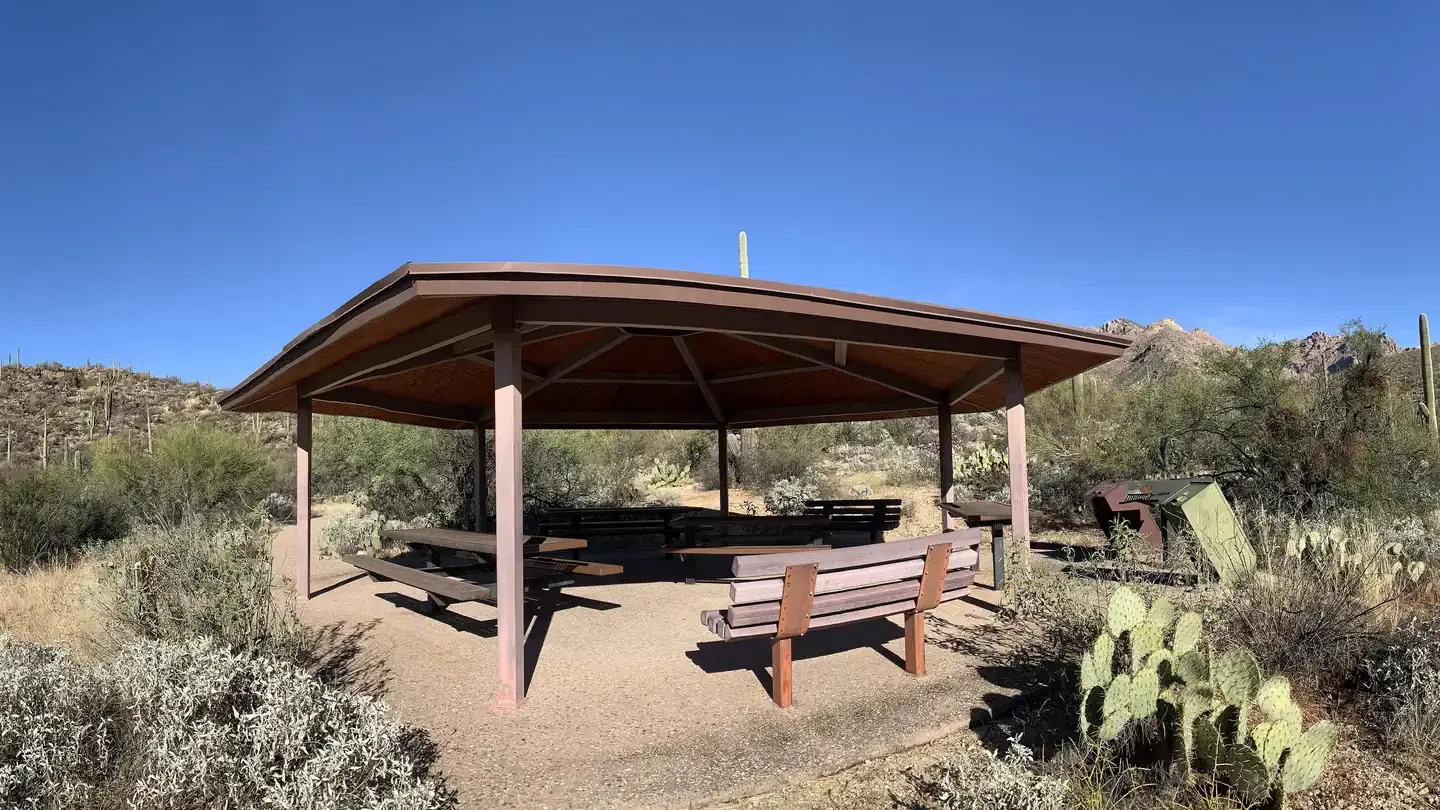 Ramada 2, covered with picnic tables, benches, trash cans, and grills