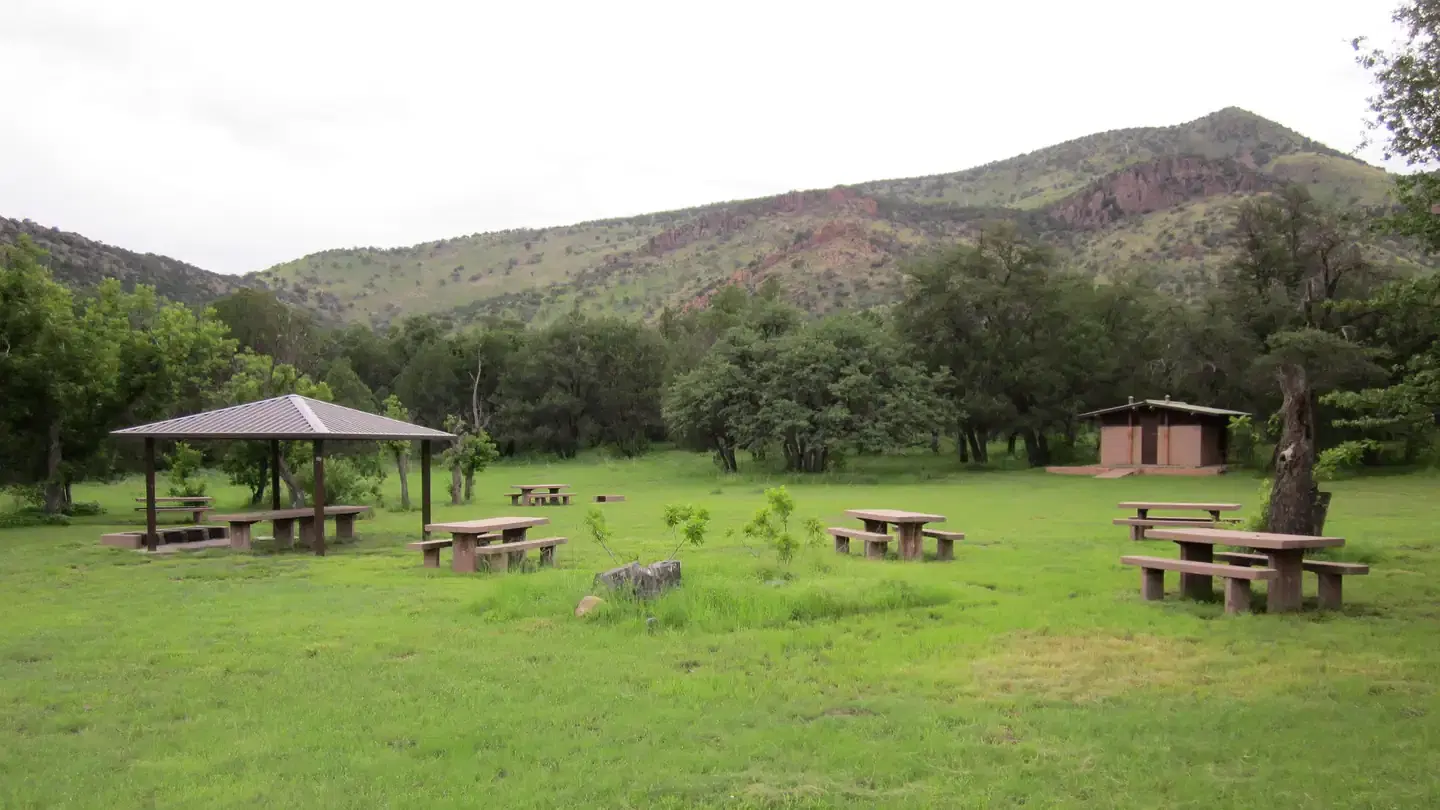 Grassy picnic area with bathroom and small ramada